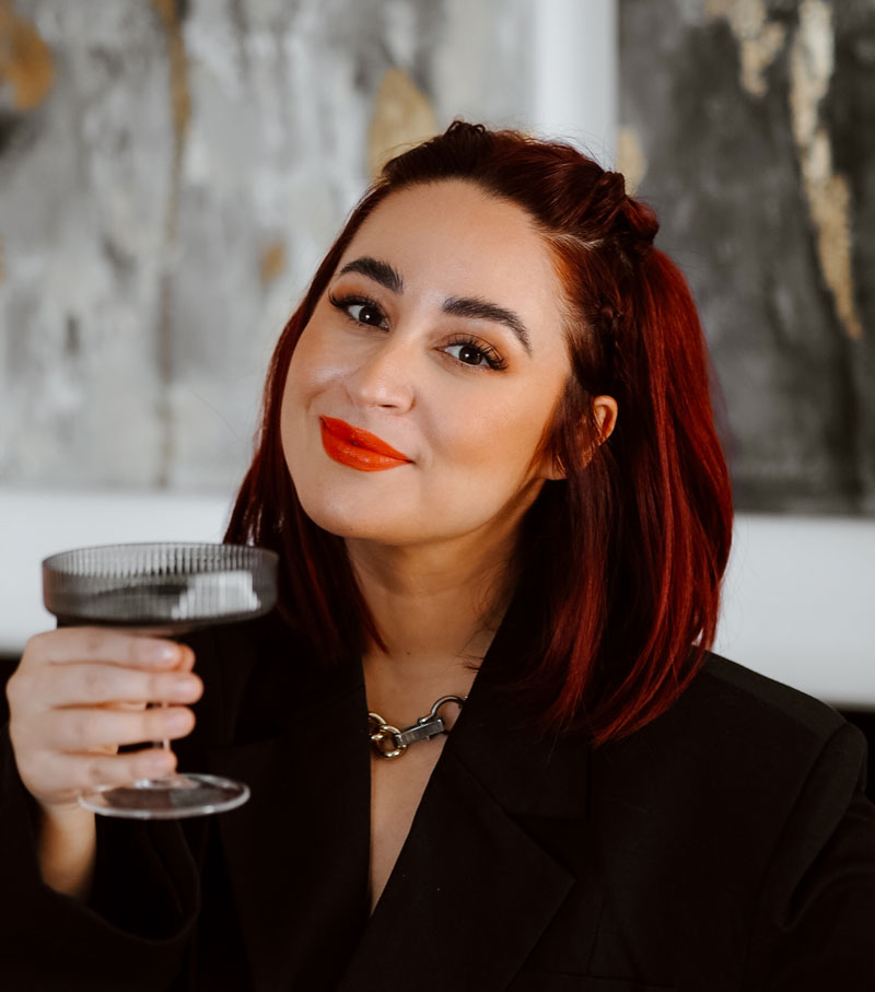 Frisur Idee Silvester Frau lächelt in die Kamera mit Glas in der Hand