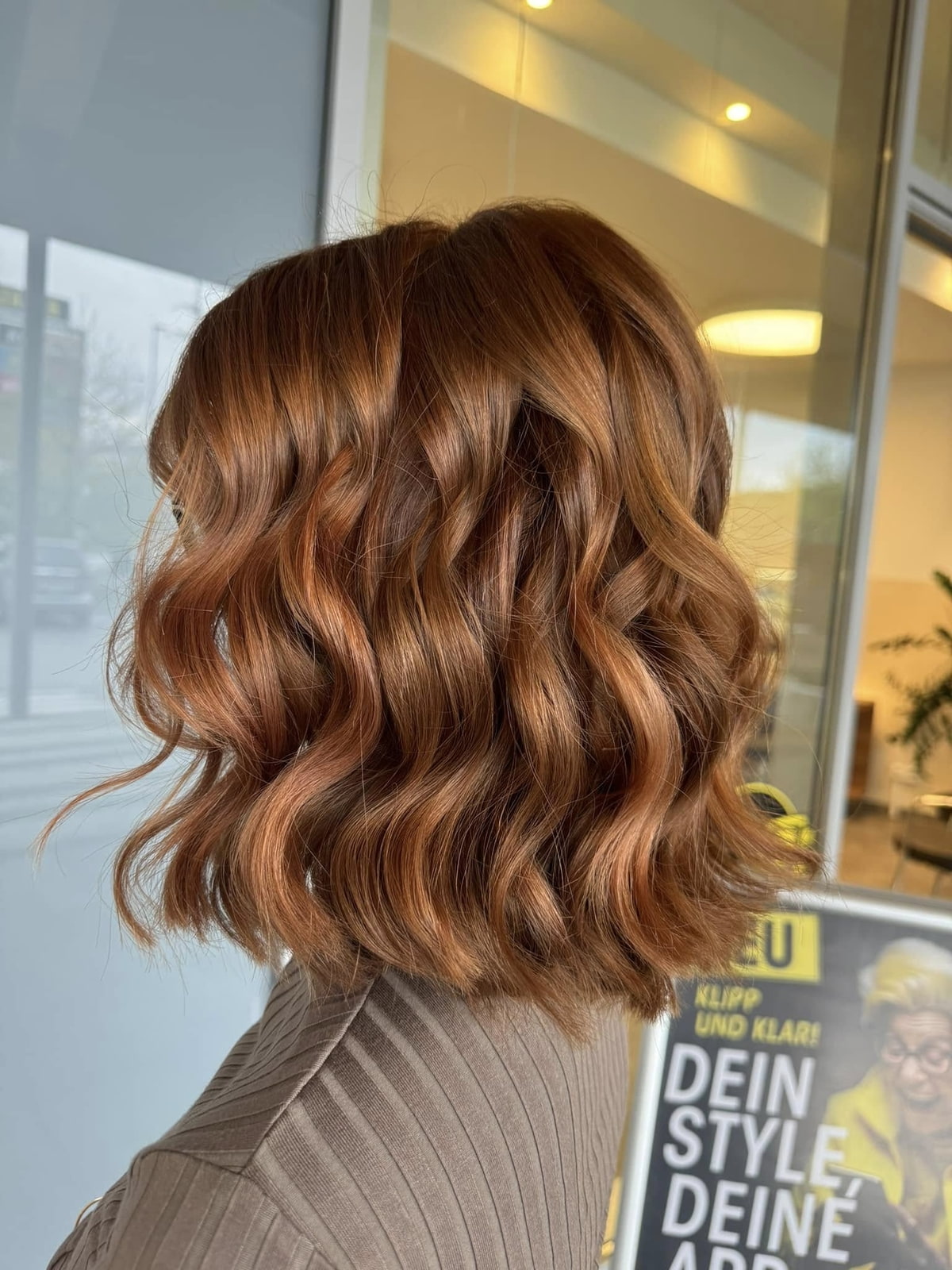 Pflege nach der Farbbehandlung Detailaufnahme von einem kupferfarbenen Bob mit Locken